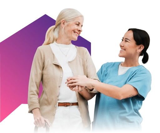 Smiling elderly woman with younger woman embracing