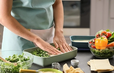 Person preparing healthy meal with vegetables