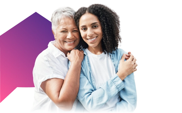 Smiling elderly woman with younger woman embracing