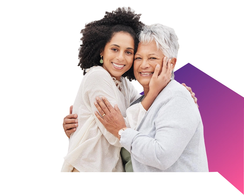 Smiling elderly woman with younger woman embracing