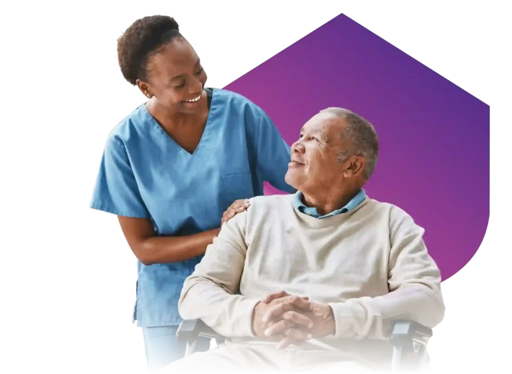 A female caregiver talks to an elderly man.
