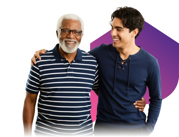 An older man in a striped shirt smiles, arm around a younger man in navy. They share a joyful moment against a gradient purple background.