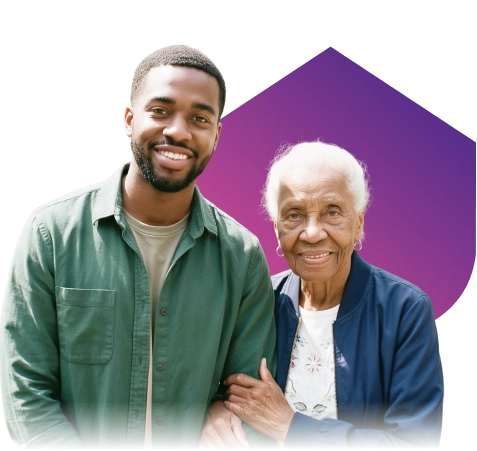 A young man in a green shirt and an elderly woman in a blue jacket smile warmly, standing close with a purple geometric shape in the background.