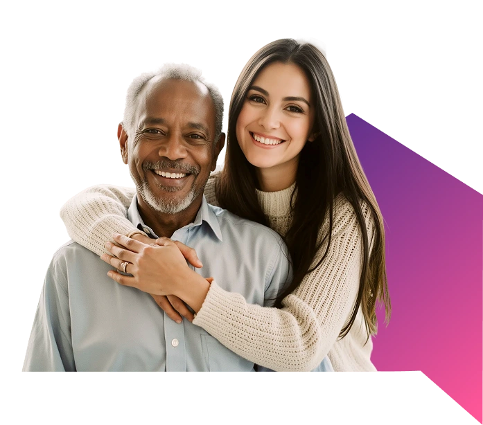 A smiling older man in a blue shirt and a young woman in a cream sweater embrace warmly, set against a black background with a purple gradient accent.