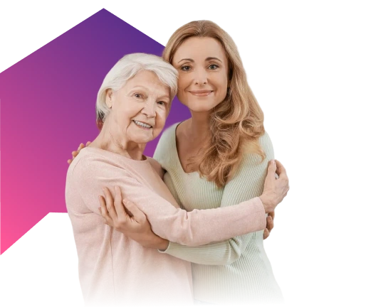 Caregiver hugging her elderly mother and smiling against a colorful background.