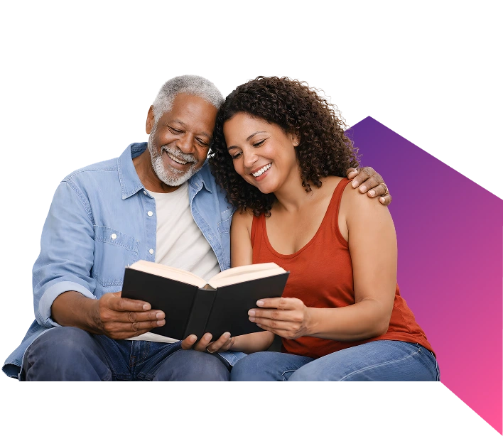 Caregiver cutting an elderly man’s hair in a bright living room.