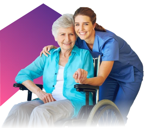 Smiling elderly woman sitting in a wheelchair with a supportive female nurse in blue scrubs hugging her from behind against a purple gradient background.
